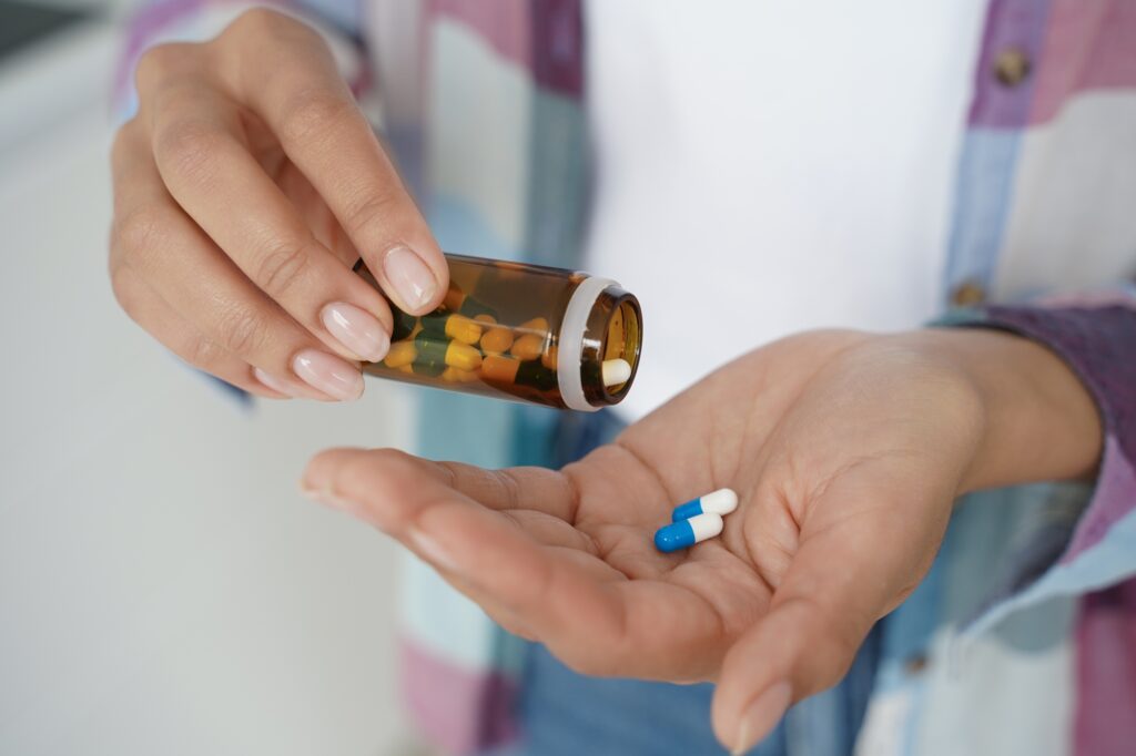 person-taking-pills-after-learning-How-to-get-a-prescription-without-insurance