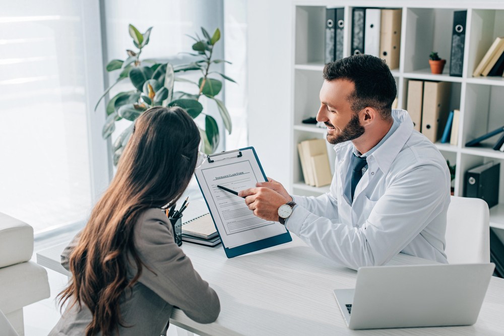 doctor talking to patient with affordable medical assistant programs online