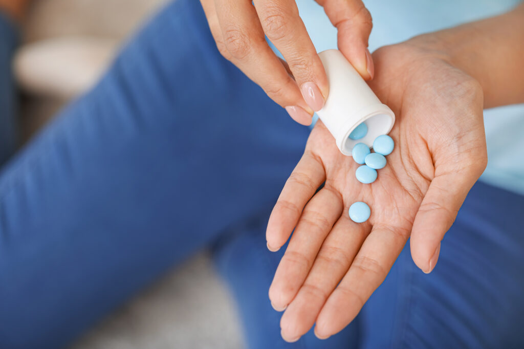 woman holding pills after online purchase of prescription drugs