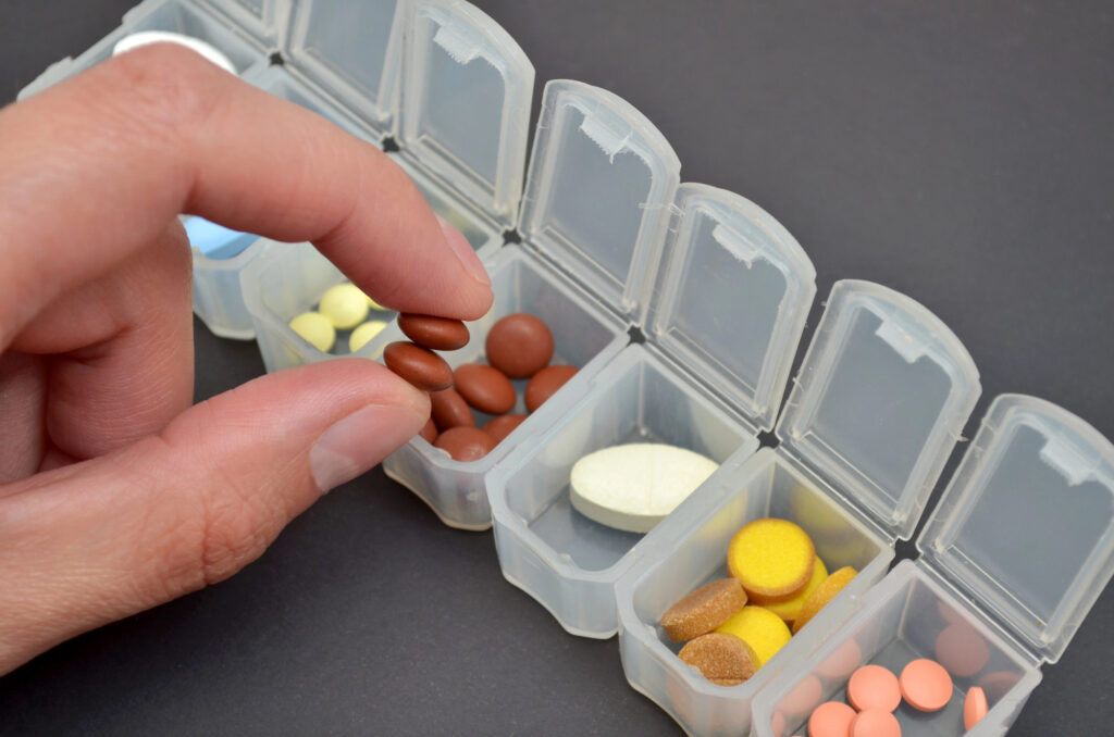 person arranging their medication from Alabama Prescription Assistance Program